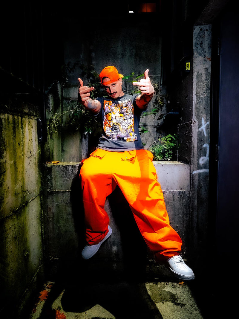 Trick or Trap Tee styled with orange pants in alleyway — Trap & Nap lookbook